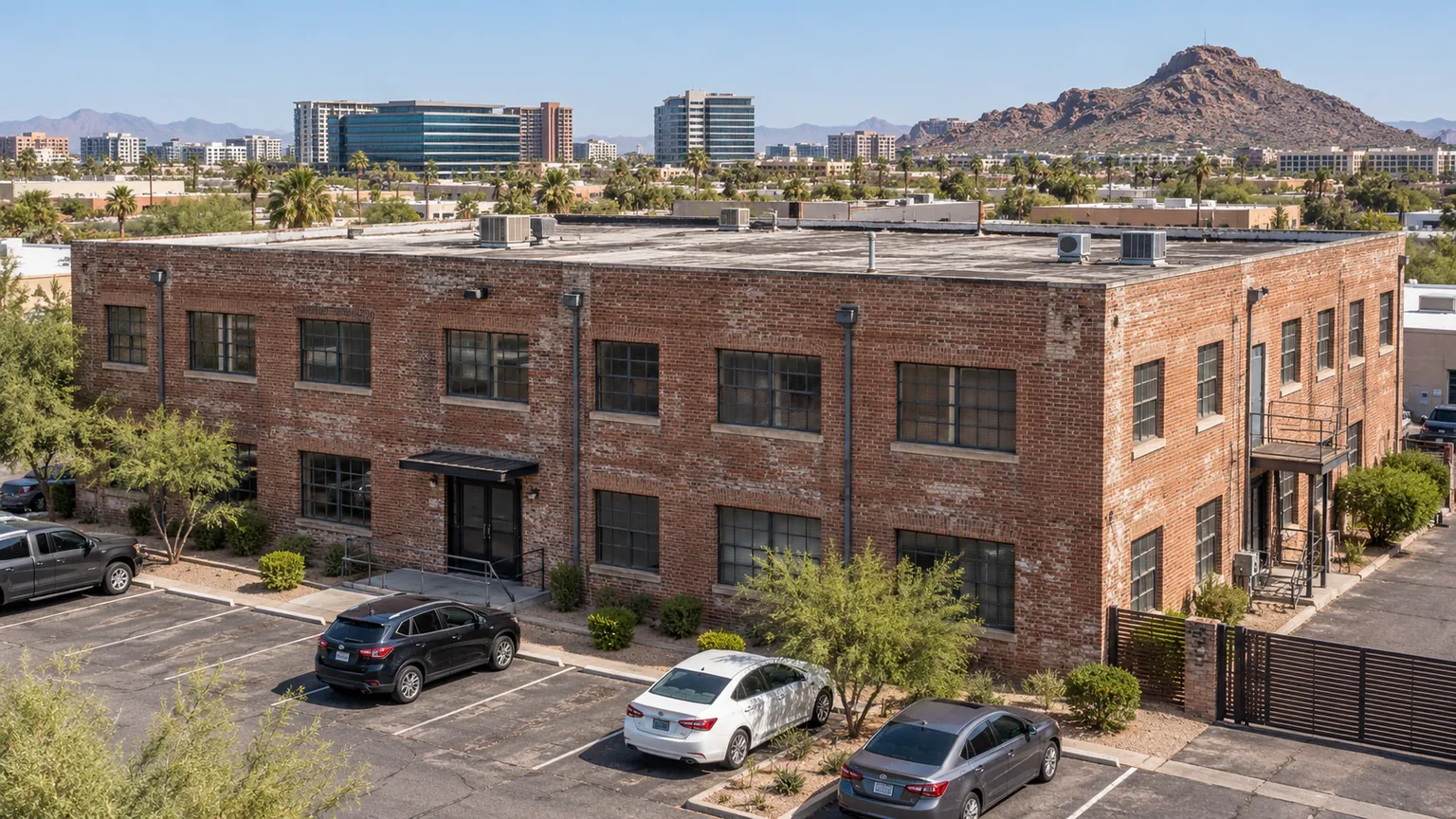 Older two-story brick commercial building with a flat roof near Guadalupe, AZ
